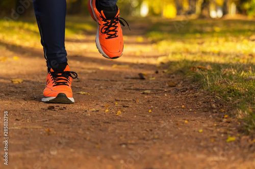 Man's legs in park while running, copy space available