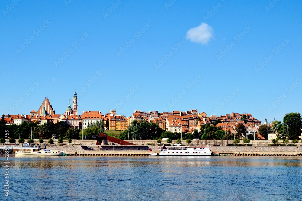 View of the Old Town - historic quarter of Warsaw with Royal Castle and red roof tenements seen from the Vistula river side. Warsaw, Poland