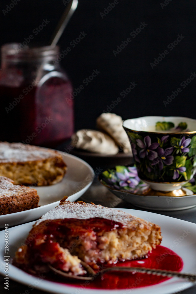 jam in a jar, tea and cake on a dark background