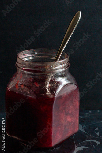 jam in a jar, tea and cake on a dark background