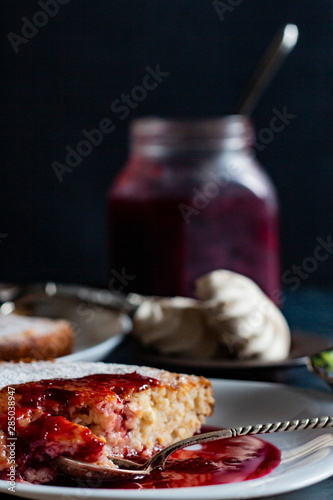 jam in a jar, tea and cake on a dark background