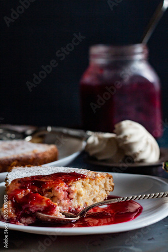 jam in a jar, tea and cake on a dark background