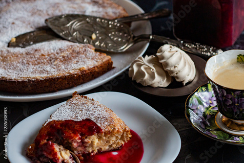 jam in a jar, tea and cake on a dark background