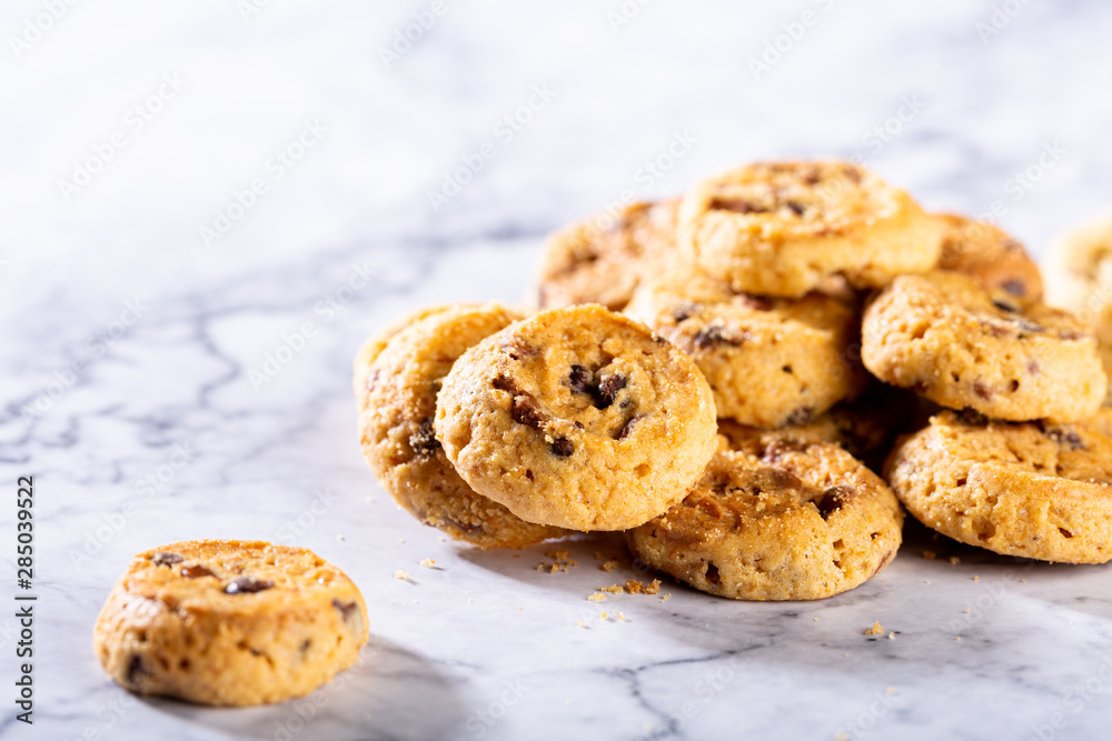 Pile of chocolate chip cookies on marble stone background. Selective focus. Copy space. Pile of chocolate chip cookies on marble stone background. Selective focus. Copy space.