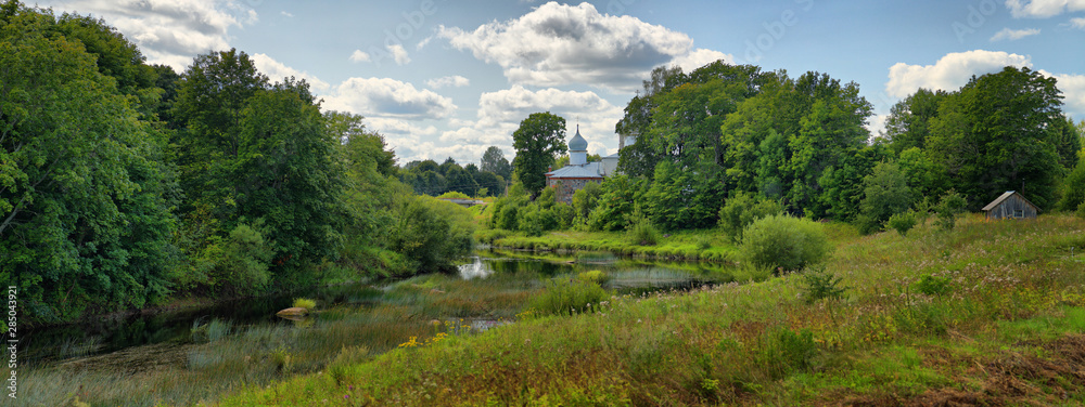 Summer panorama with river and Church