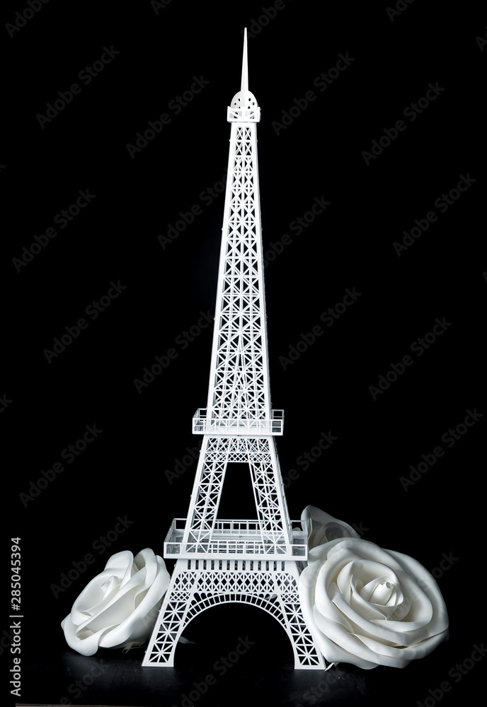 White Eiffel tower on the black background with white giant big roses flowers