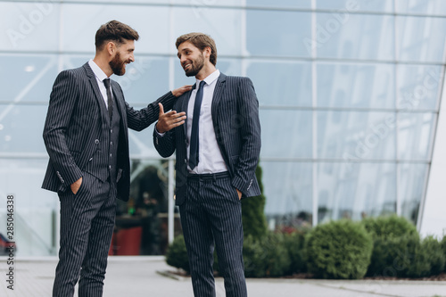 Two businessmen discussing together © pokryvka