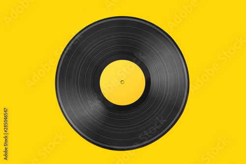 Vinyl record on a colored background. Old vintage vinyl record isolated on yellow background