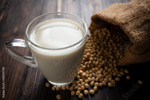 Soy milk and soy bean on wooden table background.