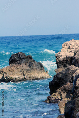 wavy sea and rocks and beach