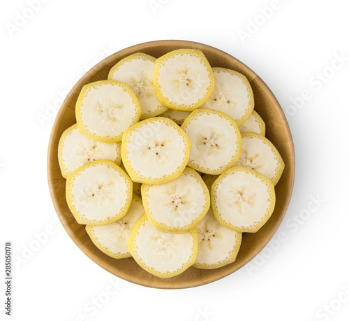 banana slice in wood bowl isolated on white background. top view
