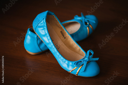 Obraz na plátne Pair of blue leather ballet flats on wooden background