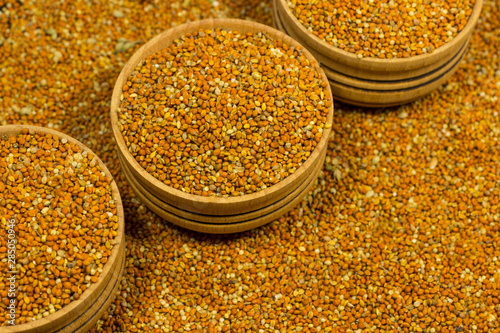 Red millet grains in wooden boxes