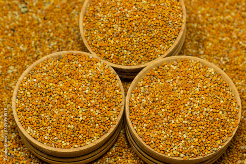 Red millet grains in wooden boxes