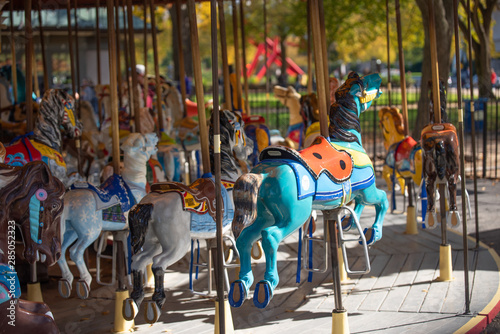Beautiful Colorful old carousel in a National mall park in Washington, DC. Merry go round with vintage wooden horses during fall or autumn season.