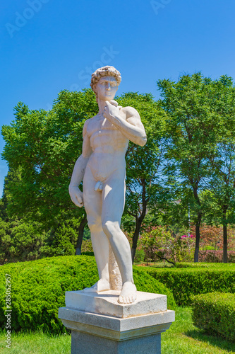 Outdoor blue sky and green trees, David sculpture, Michelangelo 1501—1504