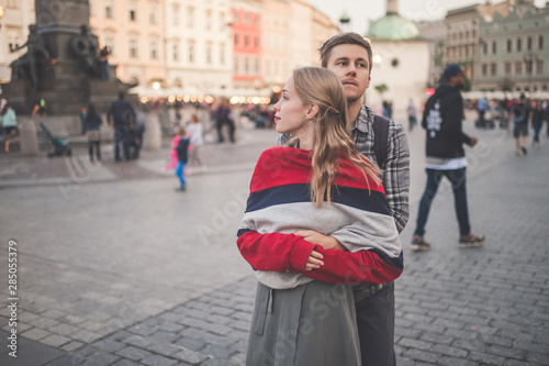 Young loving couple hugs at central square in Krakow (Cracow). © benevolente