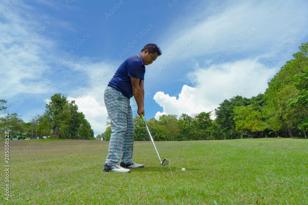 Fototapeta premium Golfer playing golf in beautiful golf course in the evening golf course with sunshine
