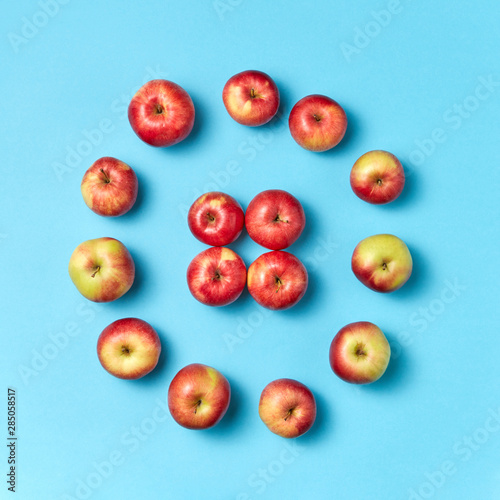 Round apples frame on a blue background.