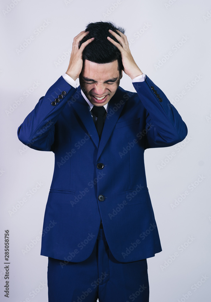 Portrait handsome young asian .businessman wearing a blue suit excitement or celebrating his victory sign isolated on grey background in studio. Asian man people. business success concept. Portrait handsome young asian .businessman wearing a blue suit excitement or celebrating his victory sign isolated on grey background in studio. Asian man people. business success concept.