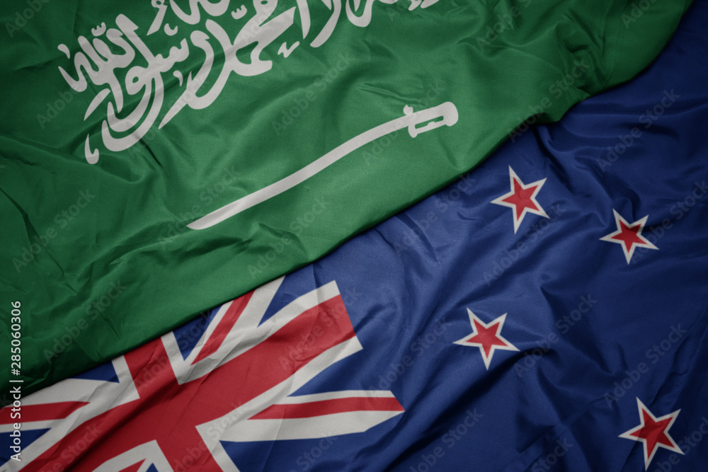 waving colorful flag of new zealand and national flag of saudi arabia. waving colorful flag of new zealand and national flag of saudi arabia.