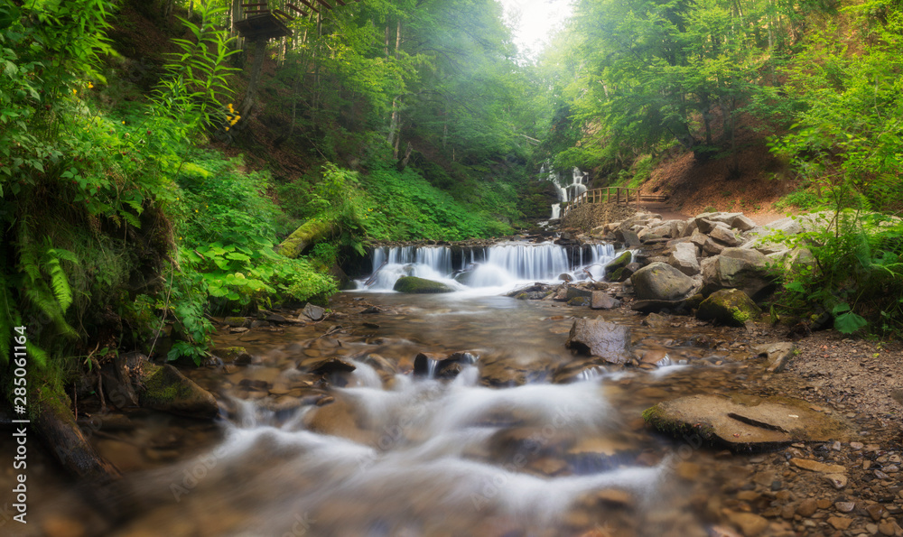 Obraz premium Long exposure panorama of the rainforest with cascades and waterfalls of Semuc Champey in the Peten jungle and rainforest of Guatemala. Noises and large grain - stylization under the film. Soft focus