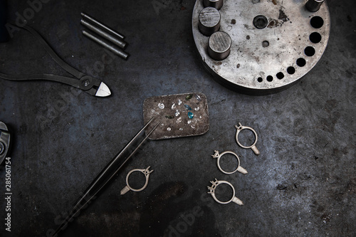 Craft jewelery making with professional tools. A handmade jeweler process, manufacture of jewellery. Working desk for craft jewelery making with professional tools.