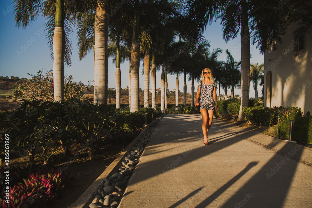 Young Woman Walking through a Luxury Resort