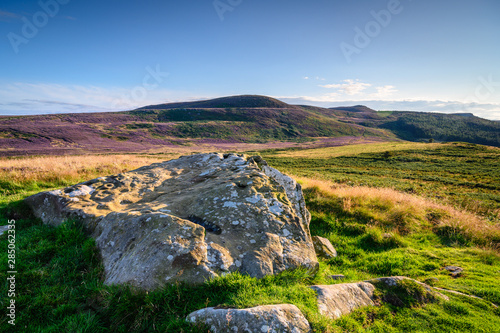 Lordenshaws Prehistoric Rock mirrors Simonside Hills Ridge, the Hillfort is located near Rothbury in Northumberland National Park and has several large stones with prehistoric rock art  photo