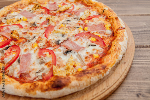 Pepperoni Pizza with Mozzarella cheese, Ham, Tomatoes, pepper, Spices . Italian pizza.