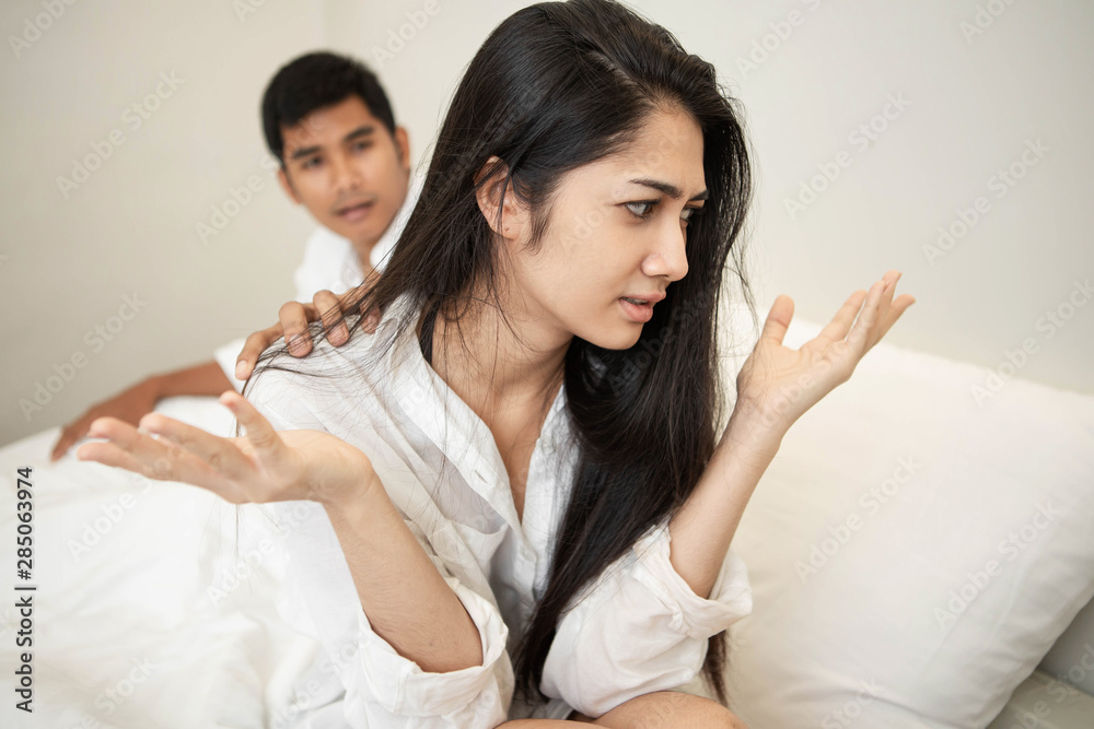 Unhappy Married Couple and Sexual Problems Concept. Frustrated Man and Woman Not Talking Feeling Offended or Stubborn. Young Attractive Couple Having Problem in Bed. Unhappy Married Couple and Sexual Problems Concept. Frustrated Man and Woman Not Talking Feeling Offended or Stubborn. Young Attractive Couple Having Problem in Bed.