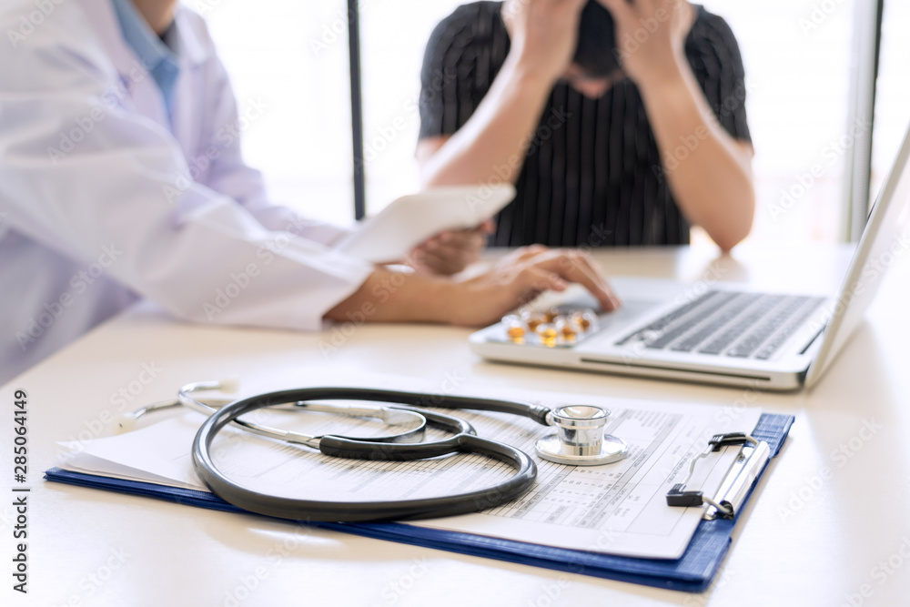 healthcare and medical ethics concept, doctor explains prescription to victim diagnosis giving a consultation and Patient listening intently in hospital. healthcare and medical ethics concept, doctor explains prescription to victim diagnosis giving a consultation and Patient listening intently in hospital.