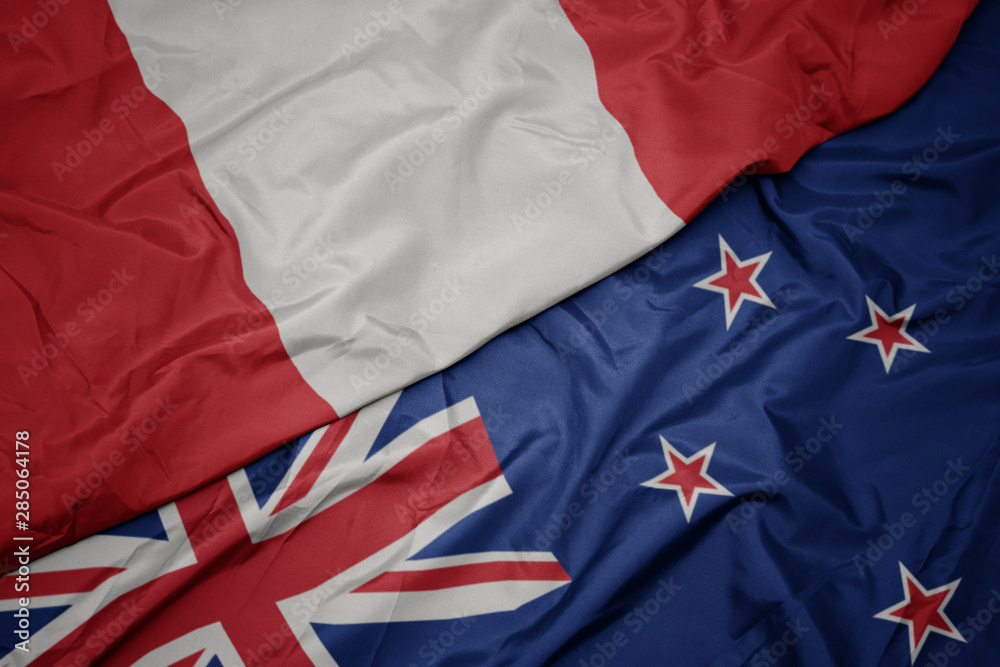 waving colorful flag of new zealand and national flag of peru. waving colorful flag of new zealand and national flag of peru.