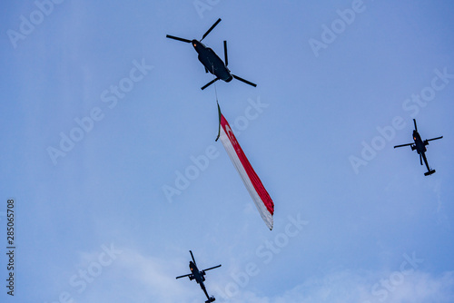 Photography State Flag flypast by three RSAF helicopters on NDP at Singapore.