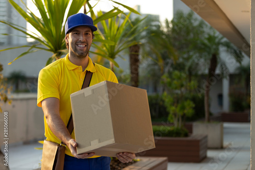 Brazilian mailman delivering a package. photo