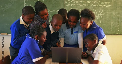 African schoolchildren with laptop in a lesson at a township school 4k photo