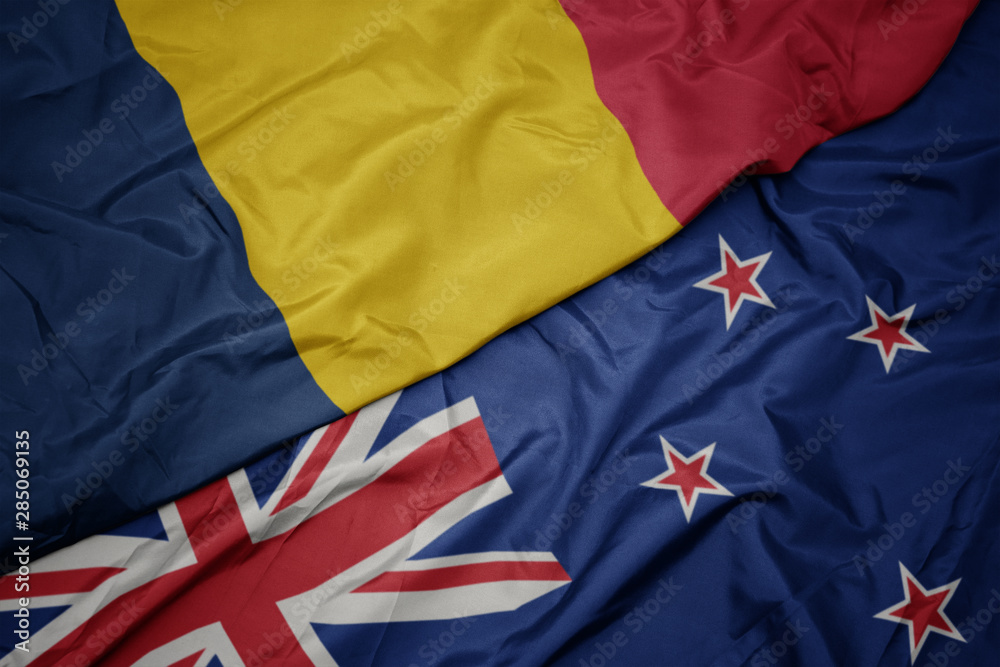 waving colorful flag of new zealand and national flag of chad. waving colorful flag of new zealand and national flag of chad.