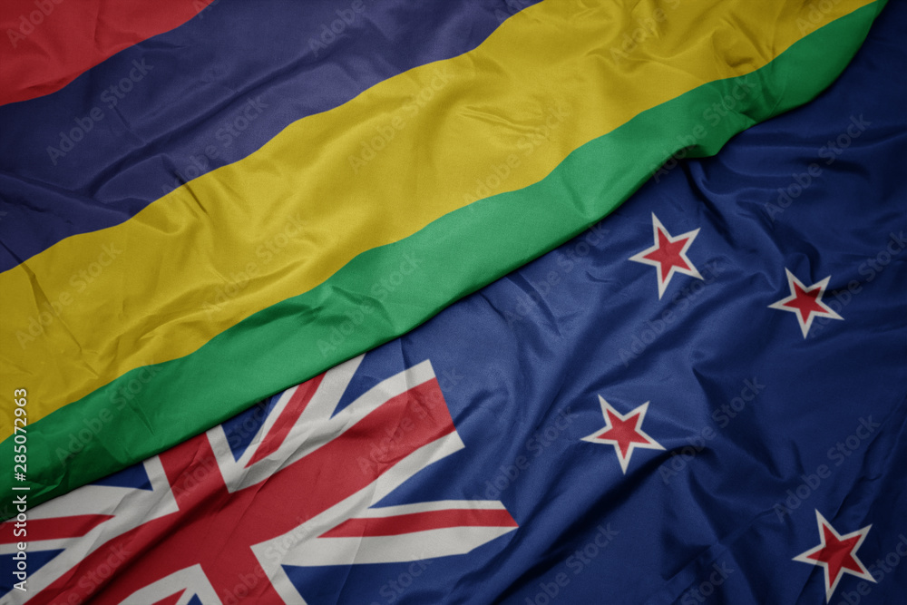waving colorful flag of new zealand and national flag of mauritius. waving colorful flag of new zealand and national flag of mauritius.