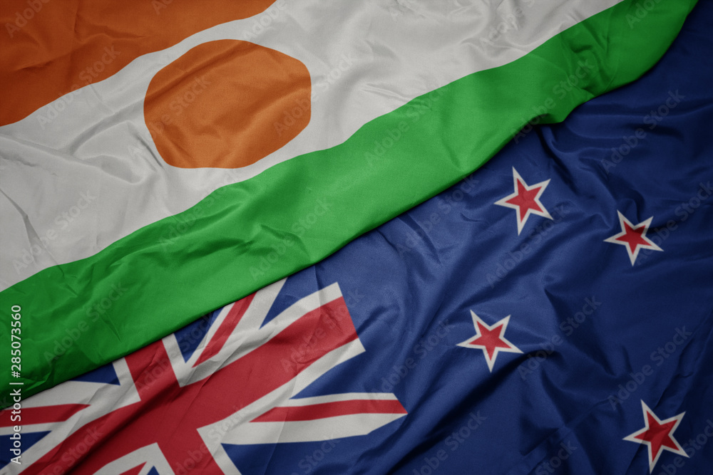 waving colorful flag of new zealand and national flag of niger. waving colorful flag of new zealand and national flag of niger.