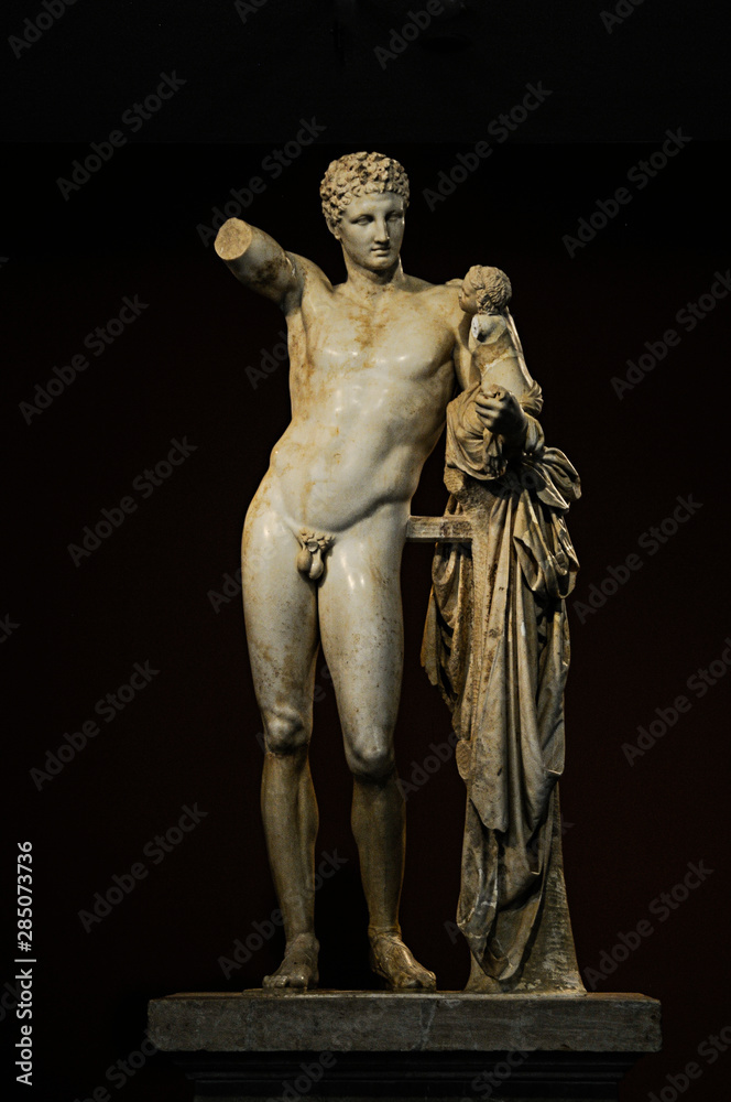 statue of greek deity on black background