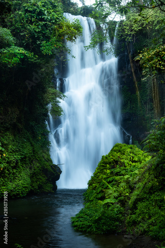 Waterfall landscape. Beautiful hidden Cemara waterfall in tropical rainforest in Sambangan, Bali. Slow shutter speed, motion photography.
