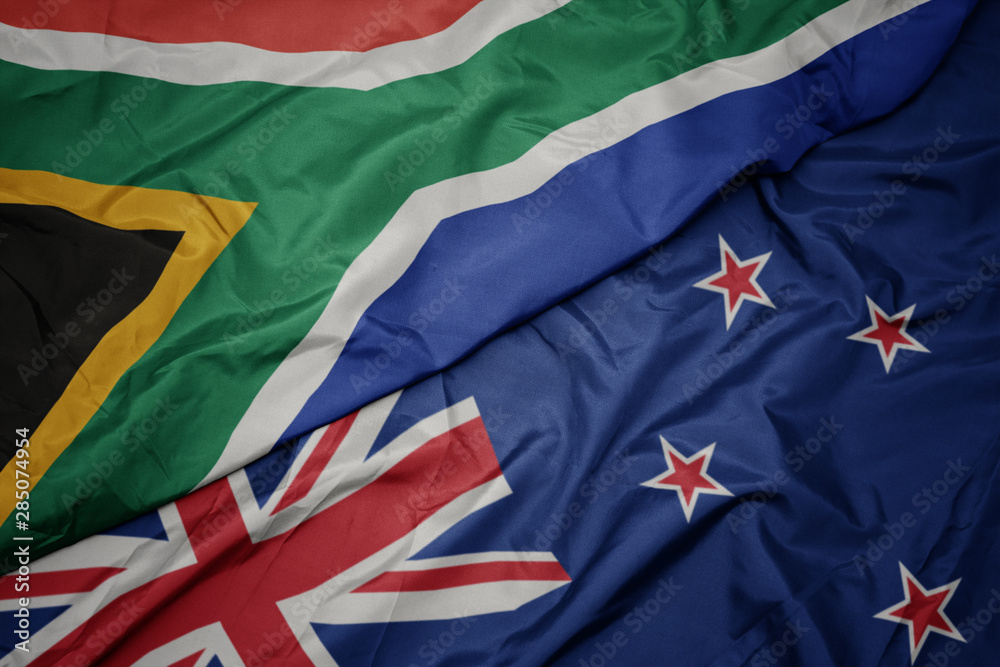waving colorful flag of new zealand and national flag of south africa. waving colorful flag of new zealand and national flag of south africa.