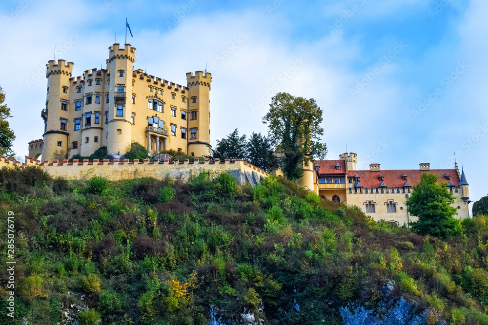 An ancient Hohenschwangau Castle on the hill under the morning sunlight in Bavaria