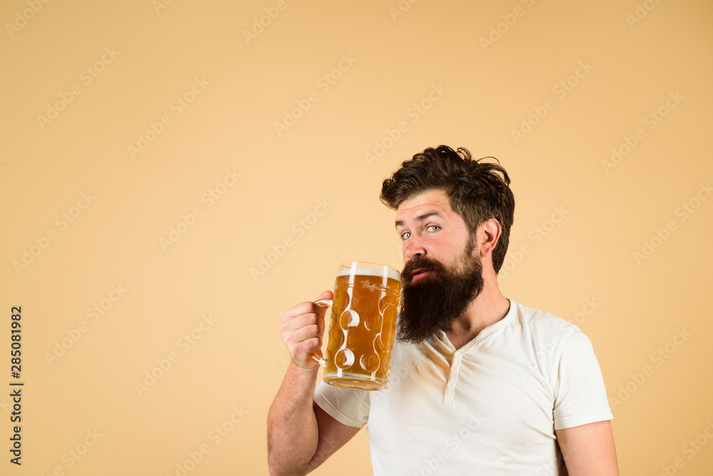 Celebration oktoberfest festival. October fest. Brewery concept. Bearded man with glass of lager beer. Barman. Beer in Germany. Man tasting draft beer. Man holds mug of beverage. Beer pub and bar.