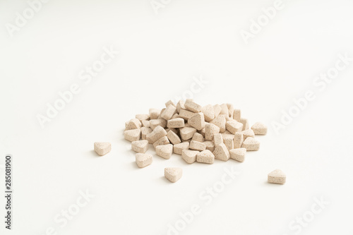 White vitamin pills on white background