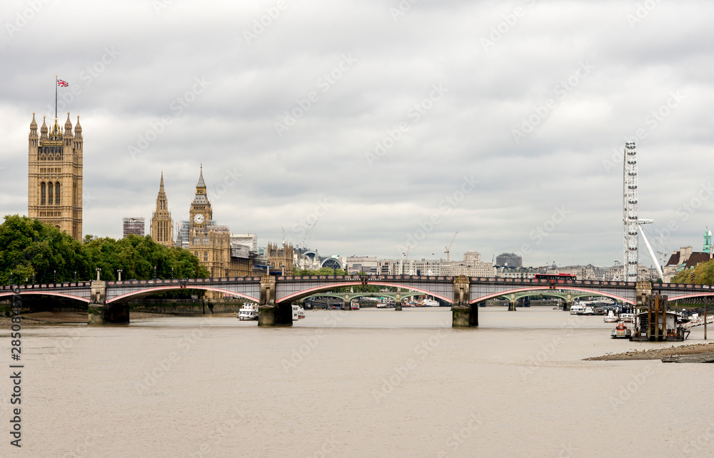 Thames river view with main London attractions on background: Big Ben, London Eye and Houses of Parliament