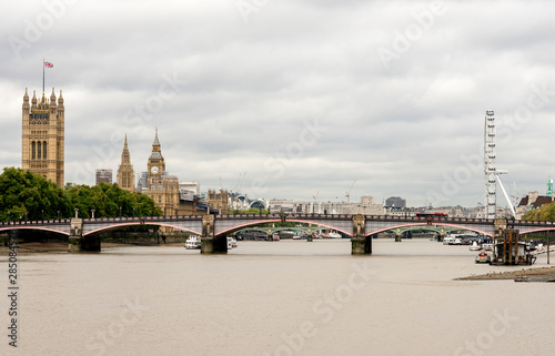 Thames river view with main London attractions on background  Big Ben  London Eye and Houses of Parliament