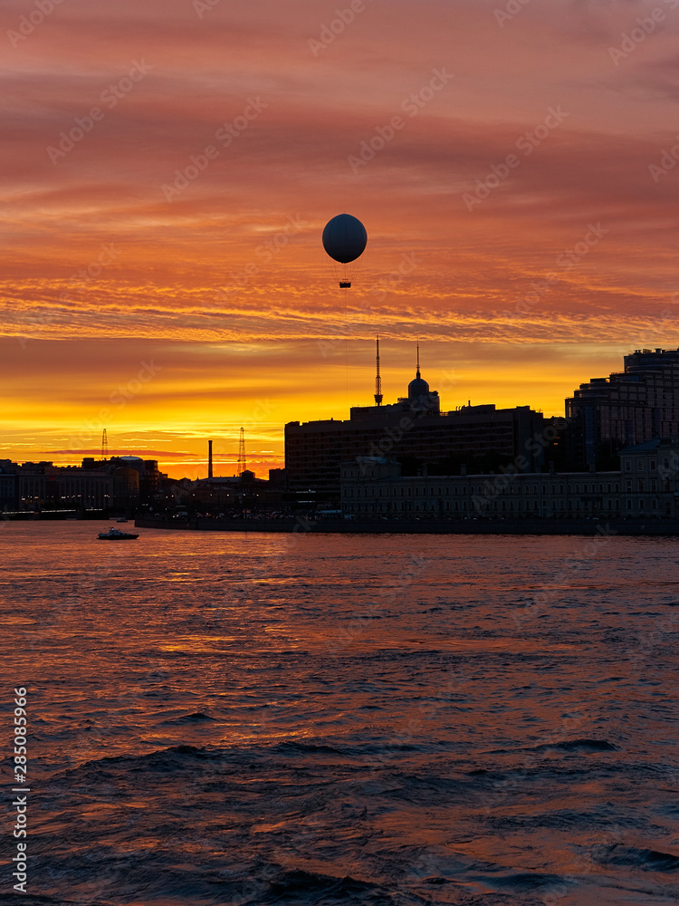 evening sunset over the city and the Neva river with a balloon in the golden sky, St. Petersburg evening sunset over the city and the Neva river with a balloon in the golden sky, St. Petersburg
