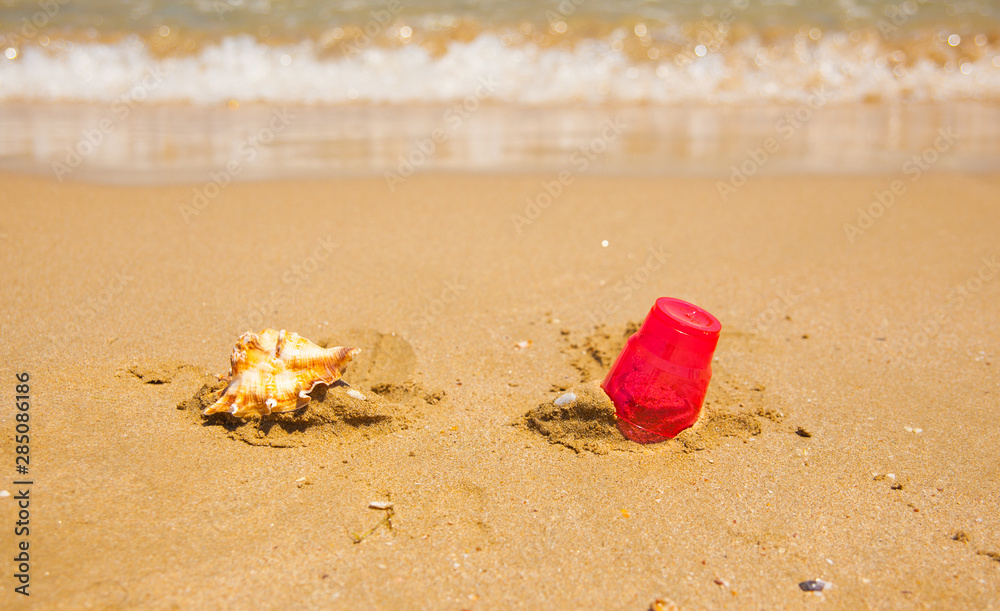 Close up plastic waste on beach after tide. Human impact on environment concept. Going Zero Waste. Pollution of the World Ocean by Plastic Close up plastic waste on beach after tide. Human impact on environment concept. Going Zero Waste. Pollution of the World Ocean by Plastic