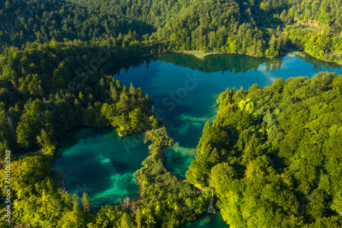 Aerial view of turquoise waters of Plitvice Lakes on a sunny summer day. Plitvice National Park, Croatia. © Kertu